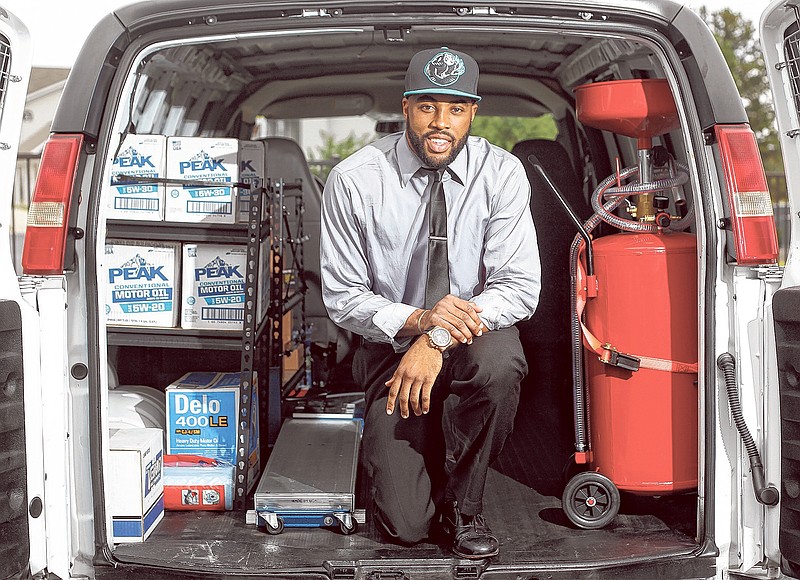 James Chapman, owner of the on-site oil change company "Change 'N' Go," is shown with his oil change van in Chattanooga.
