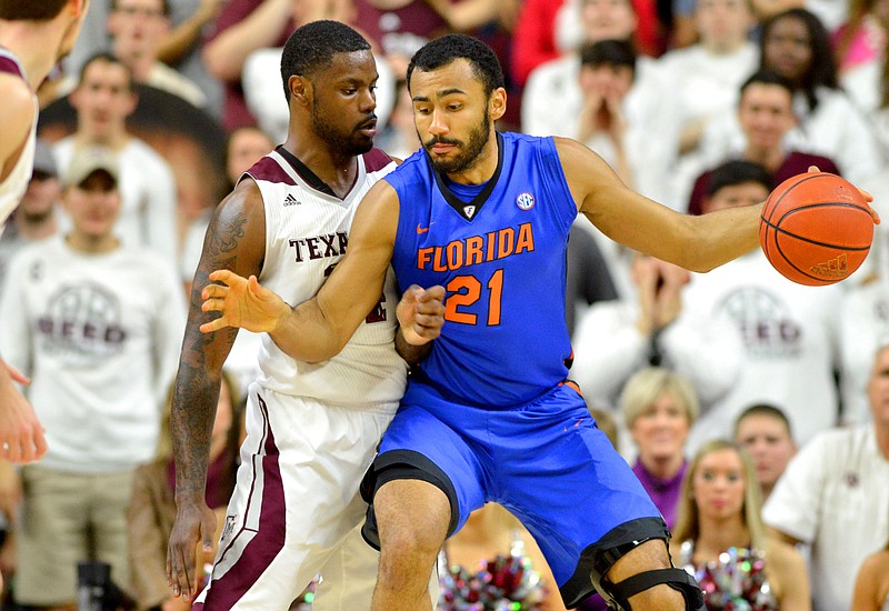 Florida's Jon Horford (21) tries to back down Texas A&M's Kourtney Roberson before making a run at the basket in the first half of an NCAA college basketball game in College Station, Texas, Saturday, Feb. 14, 2015. Texas A&M won the game 63-62.