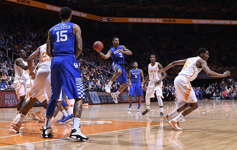 Kentucky's Robert Hubbs III (3) passes the ball outside as Tennessee's Josh Richardson (1) looks on in the first half of an NCAA college basketball game Tuesday, Feb. 17, 2015, in Knoxville.