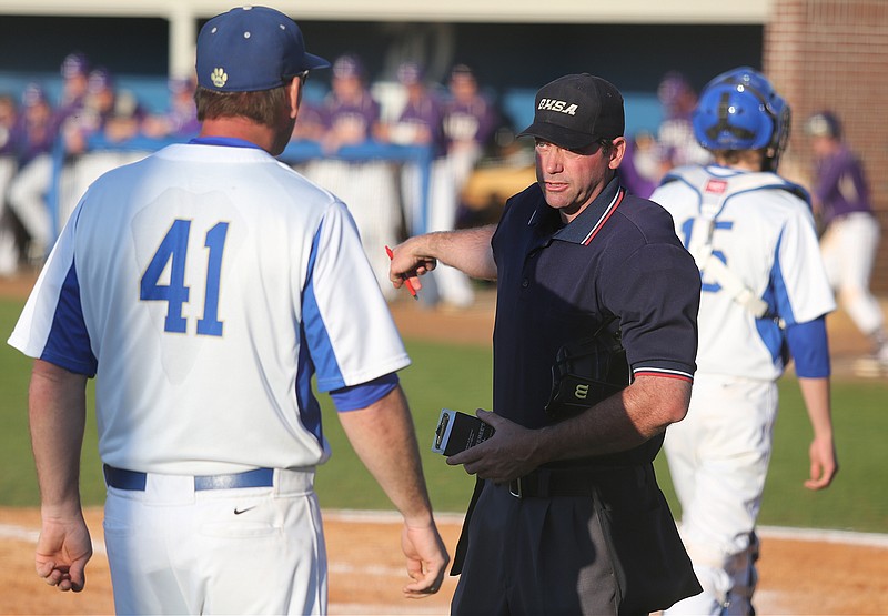 Ringgold head coach Brent Tucker speaks with the umpire during the Ringgold versus Cartersville high school baseball game on Wednesday, April 16, 2014, in Ringgold, Ga. 