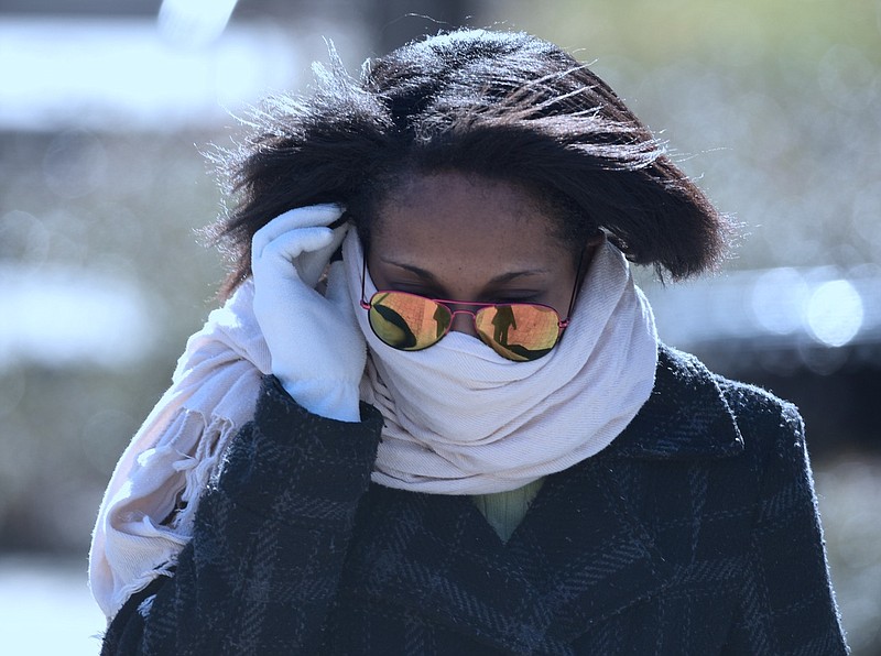 Whitney Ridley, a senior UTC student from Nashville, wears a scarf for protection from the cold wind as she walks across campus.
