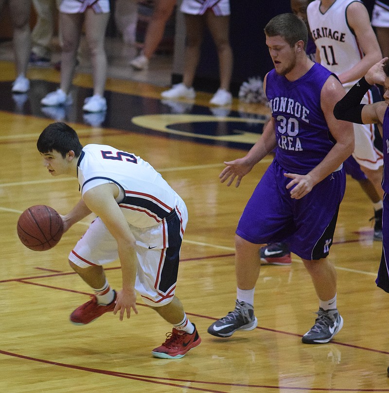 Heritage's Tyler Childers (5) breaks down court with a Monroe turnover as the Hurricane's Andrew Shoemaker (30) looks on. The Monore Area High School Hurricanes visited the Heritage High School Generals in a GSHA playoff game Wednesday, Feb. 18, 2015.