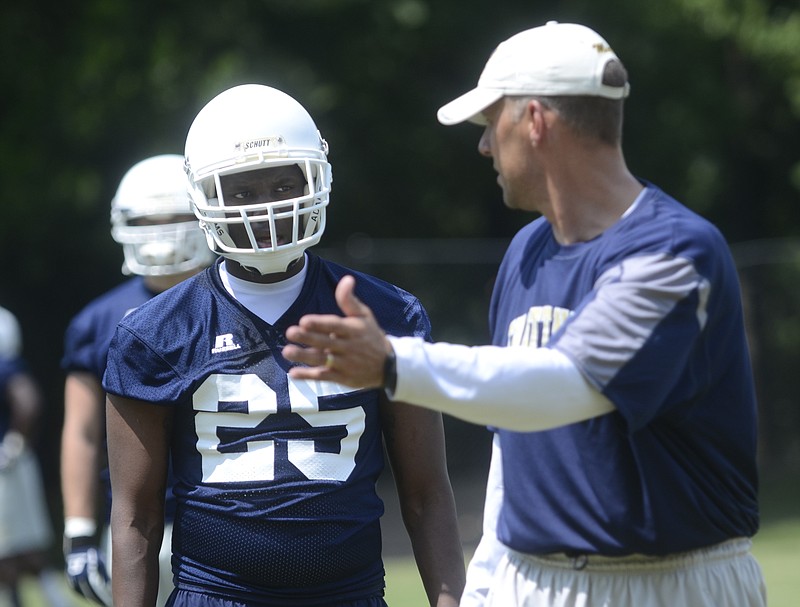UTC's Tim Whatley, left, talks with coach Rusty Wright during practice at Scrappy Moore Field in this 2014 file photo.