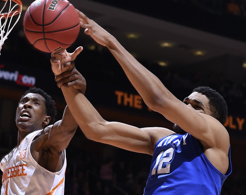 Tennessee's Josh Richardson grabs the arm of Kentucky's Karl-Anthony Towns (12) in the second half of an NCAA college basketball game Tuesday, Feb. 17, 2015, in Knoxville.