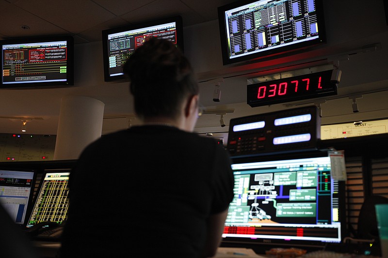 Balancing authority Cheryl Roman works at a computer station to match power load and generation at TVA in this file photo.