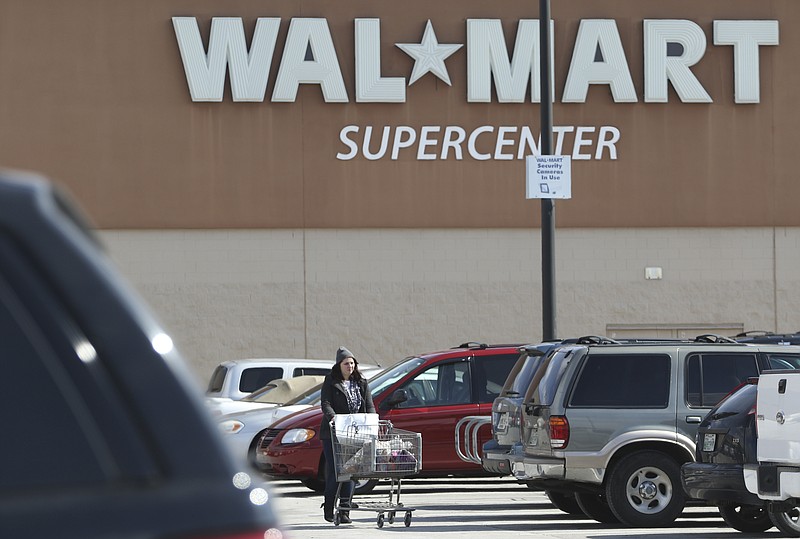 Meghann Brink makes her way to the car after shopping at the Oak Park Town Center shopping complex Walmart in Hixson, Tenn., on February 19, 2015. 