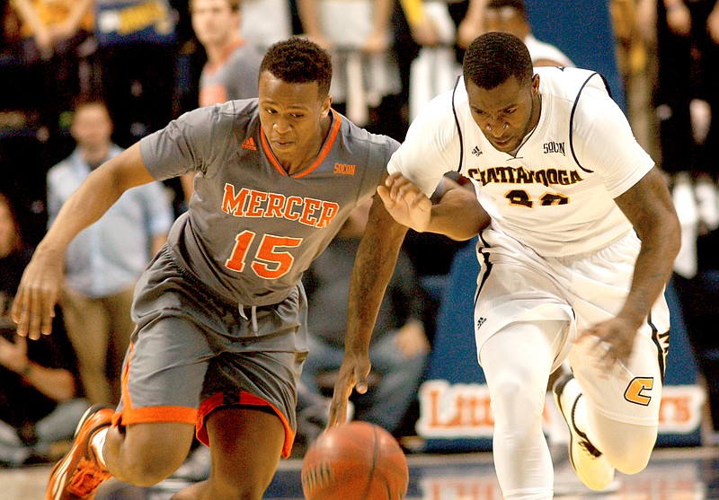 Mercer's Stephon Jelks (15) and UTC's Duke Ethridge (20) struggle for a loose ball in the first half. 