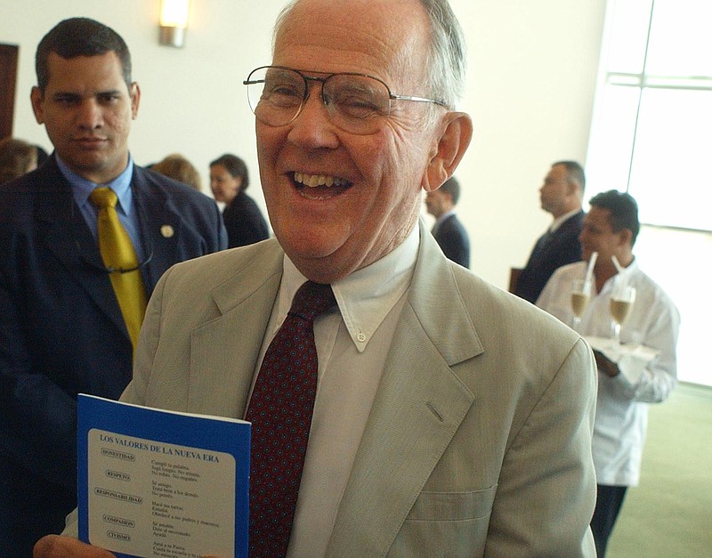 
              FILE - In this April 15, 2004 photo, U.S. Rep. Cass Ballenger, R-N.C., center, holds one of the 22,500 notebooks donated for elementary school students in Managua, Nicaragua. Ballenger, a Hickory native whose career in public service included nine terms in the U.S. House of Representatives, died Wednesday, Feb. 18, 2015. He was 88. (AP Photo/Esteban Felix, File)
            