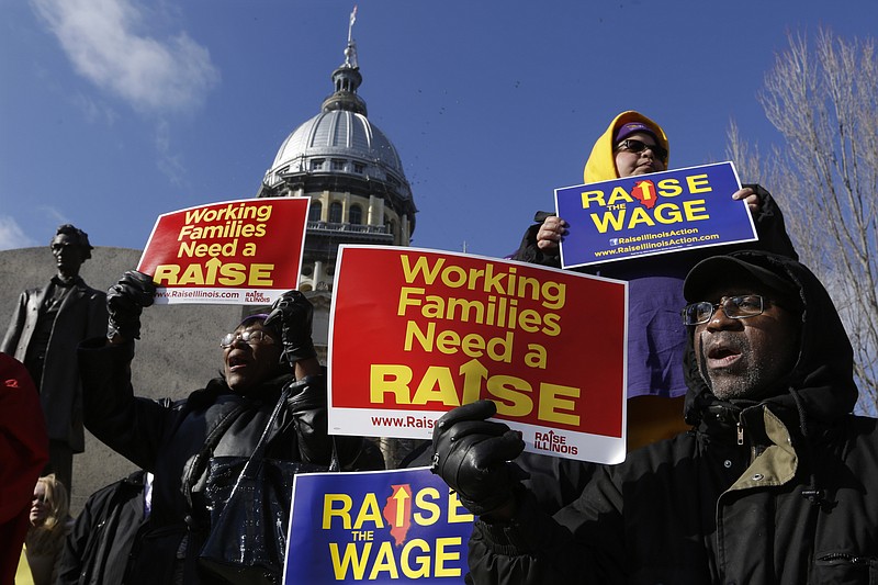 
              FILE - In this Nov. 20, 2014, file photo, supporters of legislation that will raise the minimum wage in Illinois rally outside the Illinois State Capitol in Springfield Ill. Most Americans support increasing the minimum wage, as well as requiring employers to provide paid sick leave and parental leave, according to a new Associated Press-GfK poll. Proposals to increase the federal minimum wage, as well as to require employers to give paid leave to their employees, find few objections among Americans as a whole.  (AP Photo/Seth Perlman, File)
            