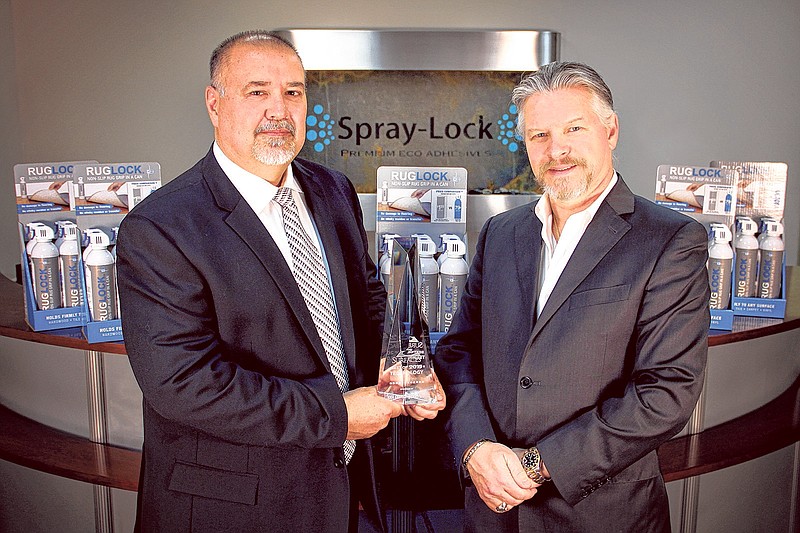 Brent Bergham, left, and Fred Land display the 2015 Technology Award their business won for its newest product, RugLock.