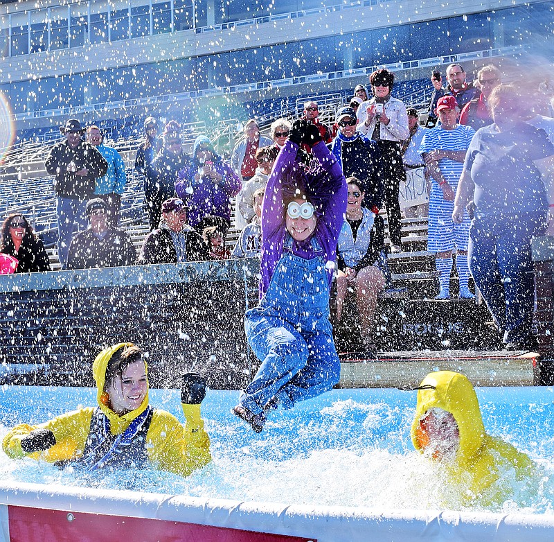 Chattanooga State Community College EMS program instructor Patrice Schermerhorn, center, is the last of her team, the "Super EMTS to the Rescue" to hit the water.  The Chattanooga Polar Plunge to benefit Special Olympics Tennessee was held at Finley Stadium.  The event raised $20,000 to support the program.