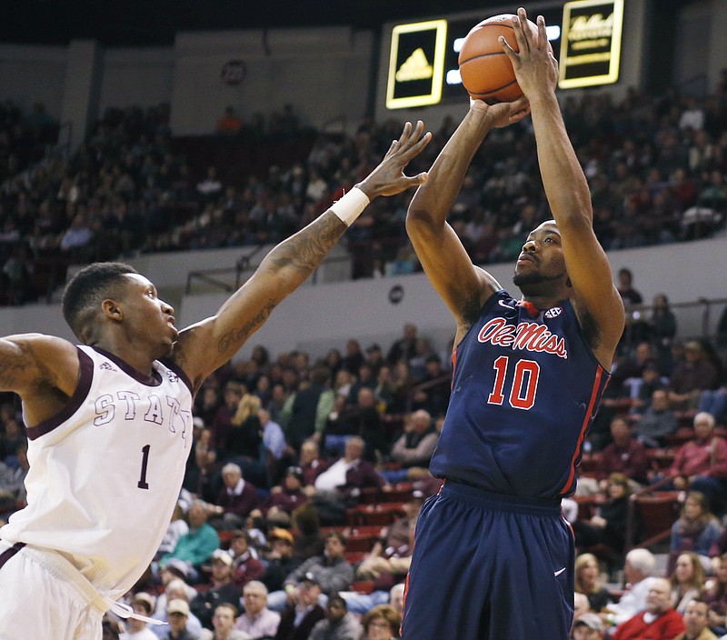 Mississippi guard Ladarius White (10) gets off a shot at the basket past Mississippi State guard Fred Thomas (1) during their game in Starkville, Miss., on Feb. 19, 2015. Mississippi won 71-65.