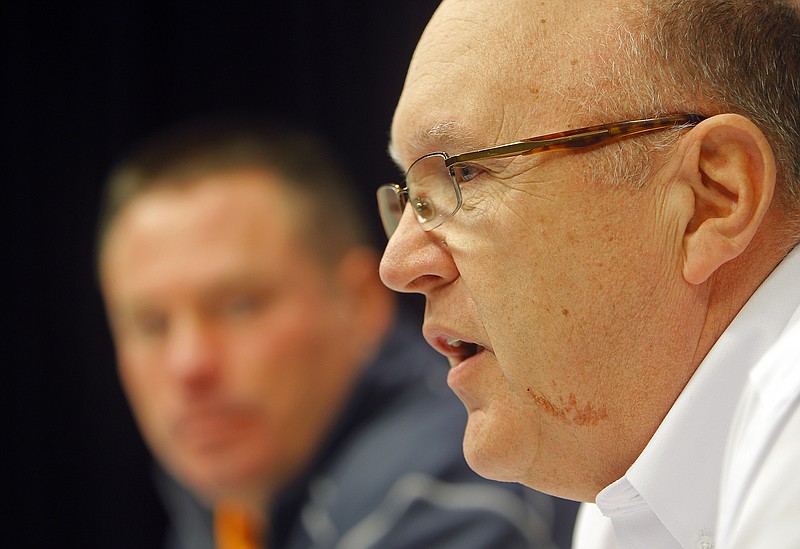 University of Tennessee NCAA college football coach Butch Jones, left, listens as Mike Debord speaks after being introduced as the new offensive coordinator in this Feb. 13, 2015, photo. 