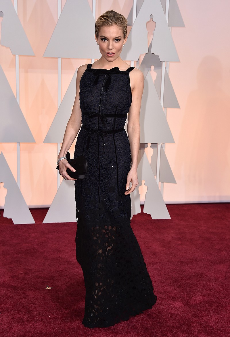 Sienna Miller arrives at the Oscars on Sunday, Feb. 22, 2015, at the Dolby Theatre in Los Angeles. 