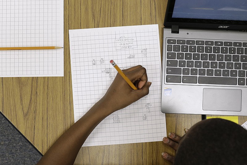 Yamarko Brown, age 12, works on math problems as part of a trial run of a new state assessment test at Annapolis Middle School in Annapolis, Md., in this Feb. 12, 2015 photo.