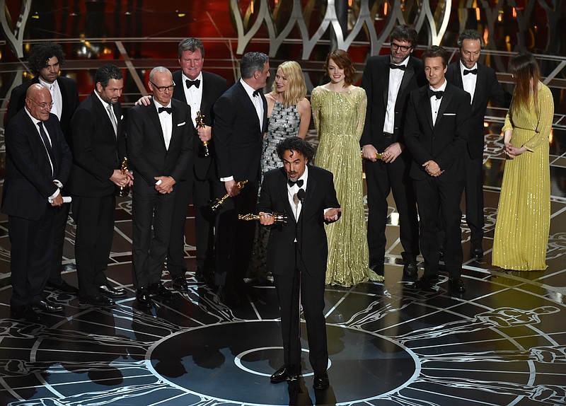 Alejandro G. Inarritu, center, and the cast and crew of "Birdman or (The Unexpected Virtue of Ignorance)" accept the award for the best picture at the Oscars on Sunday, Feb. 22, 2015, at the Dolby Theatre in Los Angeles. 