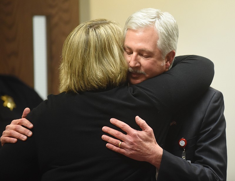 Board member Christy Critchfield hugs Superintendent Johnny McDaniel as she heads out the door upon announcing that she is resigning the school board after board members approved the buyout package for Superintendent Johnny McDaniel during a Bradley County school board meeting.