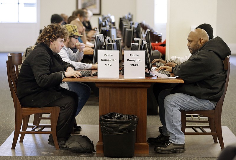 
              In this Feb. 19, 2015 photo, Larry Lawrence, left, who slept on the street the night before, works at a computer at the Nashville Public Library in Nashville, Tenn. As cuts to social services and mental health programs continue to drive the homeless and disadvantaged to use libraries as day shelters, some libraries are beginning to view services for that population as an important part of their mission. (AP Photo/Mark Humphrey)
            