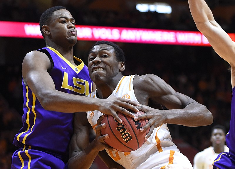 Tennessee forward Willie Carmichael III, center, struggles to drive the ball against LSU forward Jarell Martin (1) during the first half of an NCAA college basketball game in Knoxville on Saturday, Feb. 14, 2015. LSU won 73-55. 