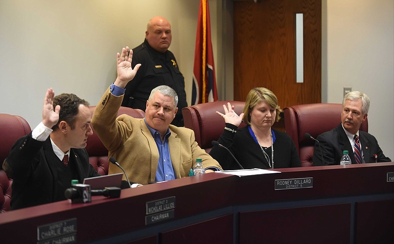 Nicholas Lillios, Rodney Dillard, and Christy Chritchfield, from left, cast their votes to keep Superintendent Johnny McDaniel, right, during a Bradley County school board meeting to vote on the buyout package for Superintendent Johnny McDaniel.