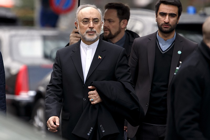 Ali Akbar Salehi, head of Iran's Atomic Energy Organization, left, leaves the hotel following a bilateral meeting with US negotiators, among them U.S. Secretary of State John Kerry, for a new round of nuclear talks in Geneva, Switzerland, Monday, Feb. 23, 2015.