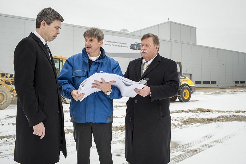 Volkswagen Chattanooga CEO Christian Koch, center, shows off plans for the plant's expansion to Mayor Andy Berke, left, and Hamilton County Mayor Jim Coppinger. Work on the expansion started in January. 