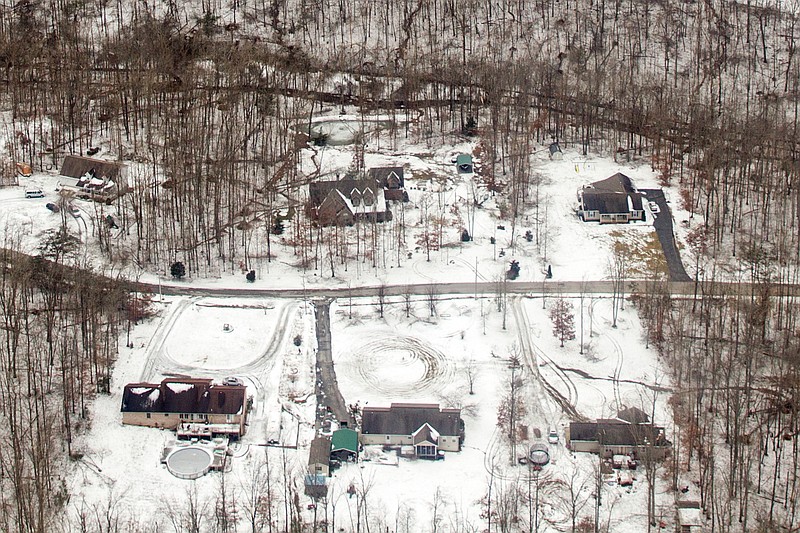 Ice and snow are seen near homes from a National Guard helicopter on the Cumberland Plateau near Crossville, Tenn., Tuesday, Feb. 24, 2015. Tennessee Gov. Bill Haslam joined state officials in touring damage from the storm, and urged people to check on their neighbors as the death toll from the storm climbs.