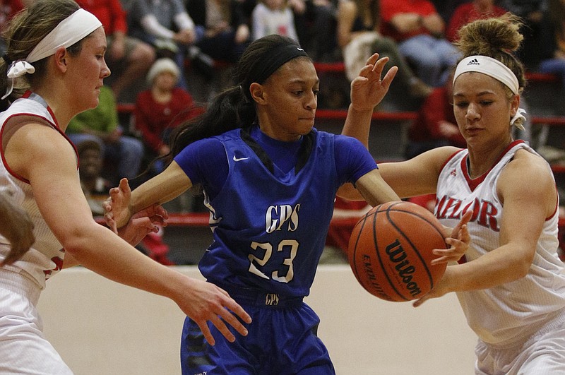 GPS's Akia Harris, center, tries to rebound the ball against Baylor's Kaleigh Clemons, right, and Selena Popp during their basketball game on Jan. 17, 2015, at Baylor School.