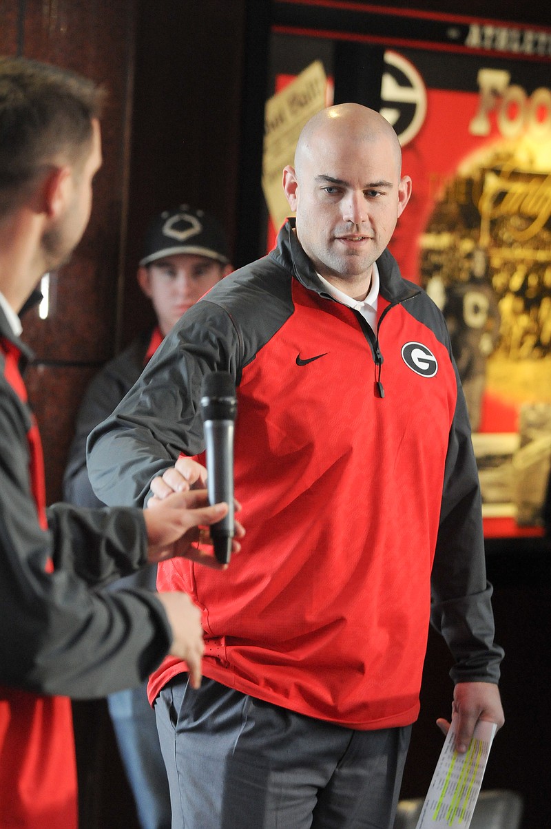 New Georgia offensive line coach Rob Sale, right, takes the microphone from new offensive coordinator Brian Schottenheimer during a national signing day ceremony earlier this month.