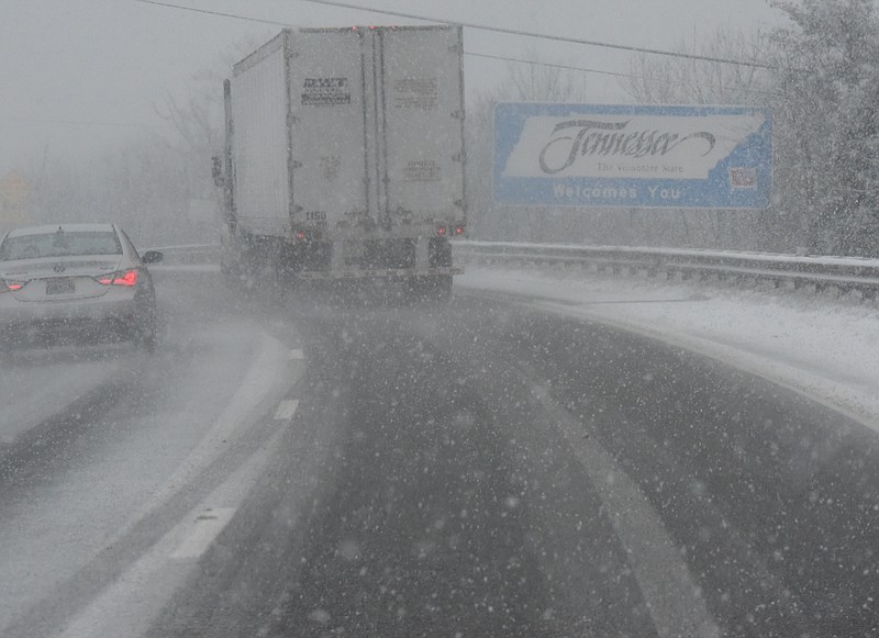 Snow begins pile up on Interstate 24, eastbound at the Tennessee state line at five o'clock Wednesday.