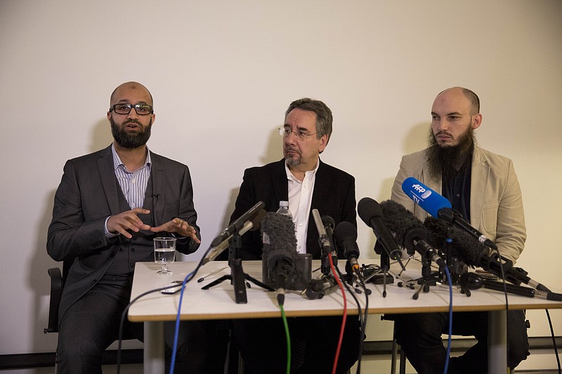 CAGE research director Asim Qureshi, left, speaks next to political activist John Rees, center, and spokesman Cerie Bullivant, right, during a news conference held by the CAGE human rights charity in London on Thursday, Feb. 26, 2015.