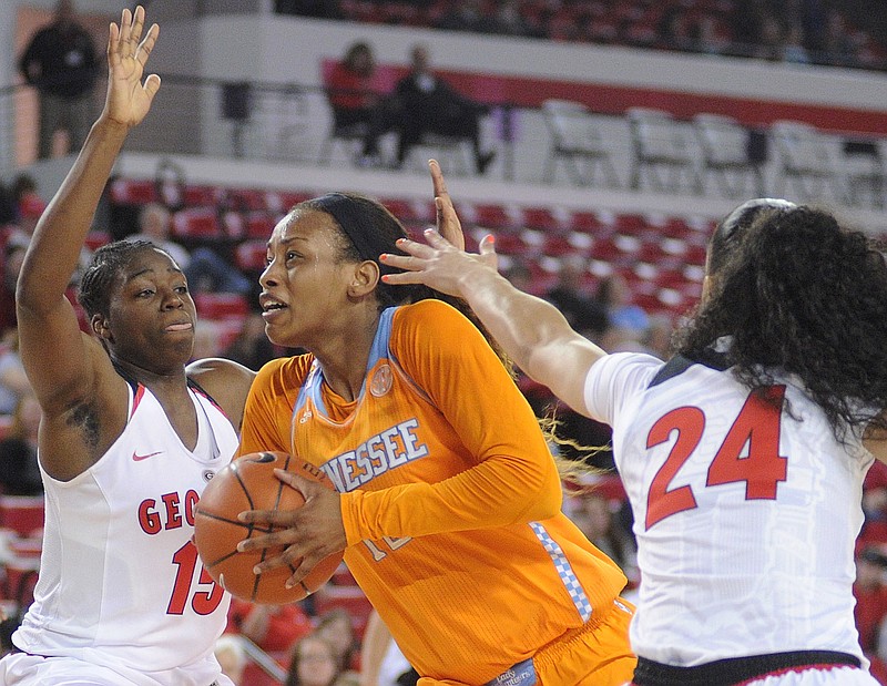 Tennessee forward Bashaara Graves, center, is pressured by Georgia forward Krista Donald (15) and Georgia guard Marjorie Butler (24) during their game Thursday, Feb. 26, 2015, in Athens, Ga.