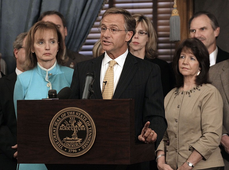 In this Jan. 10, 2012, file photo, Rep. Sheila Butt, R-Columbia, lower right, listens as Gov. Bill Haslam, center, talks about his legislative agenda on the opening day of the second session of the 107th General Assembly in Nashville.