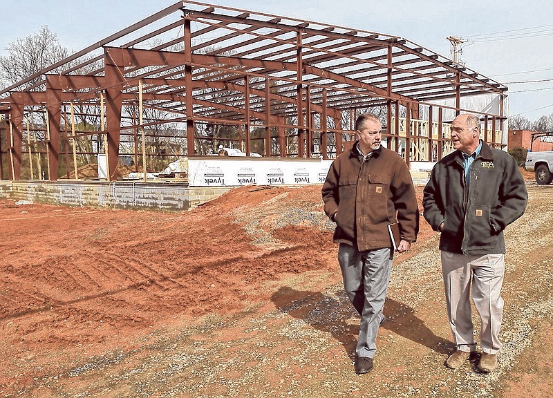 Randy Hudson, director of research and development for La-Z-Boy, left, and R. Birch Arnold, president of RBA Construction, walk the site of La-Z-Boy's new research and test facility in Dayton, Tenn.