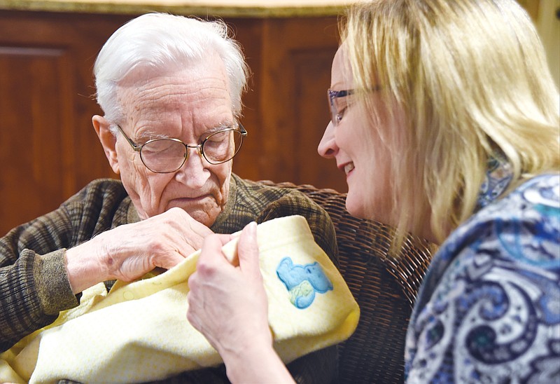 Paul Craig, 94, holds Lane, a life-like doll, as he talks with his daughter, Mary Craig Coleman, at the Lantern Alzheimer's Center in Hixson, a division of Morning Pointe Senior Living. Coleman says the center's cuddling program has given her father, who was diagnosed with Alzheimer's in 2009, a purpose each day.