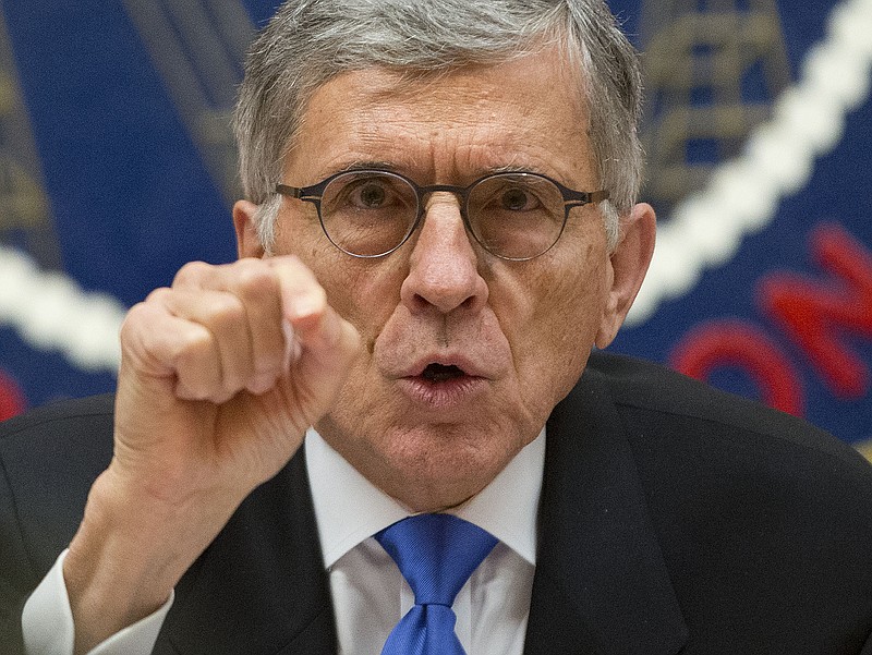 
              Federal Communications Commission (FCC) Chairman Tom Wheeler gestures near the end of a hearing for a vote on Net Neutrality, Thursday, Feb. 26, 2015, at the FCC in Washington. The FCC has agreed to impose strict new regulations on Internet service providers like Comcast, Verizon and AT&T. The regulatory agency voted 3-2 Thursday in favor of rules aimed at enforcing what's called "net neutrality." That's the idea that service providers shouldn't intentionally block or slow web traffic, creating paid fast lanes on the Internet. (AP Photo/Pablo Martinez Monsivais)
            