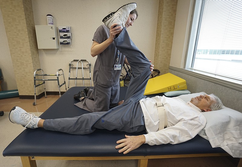 Physical Therapist Cara Goins, left, works with Ponder Geren at Siskin Rehabilitation Hospital on Tuesday, February 24, 2015, as he recovers from a stroke. 