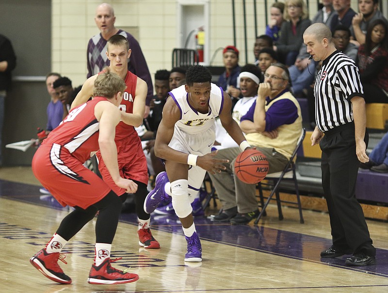 Central High School's Ryan Montgomery (11) dribbles past Loudon's JaMichael Poole (20) and Jacob Arden (10) during the Region 3-AA tournament at the Purple Pounders home court Friday, Feb. 27, 2015.