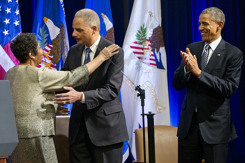 
              Singer Aretha Franklin, left, hugs outgoing Attorney General Eric Holder, as President Barack Obama applauds, at an event celebrating Holder at the Department of Justice in Washington, Friday, Feb. 27, 2015. Franklin (AP Photo/Jacquelyn Martin)
            