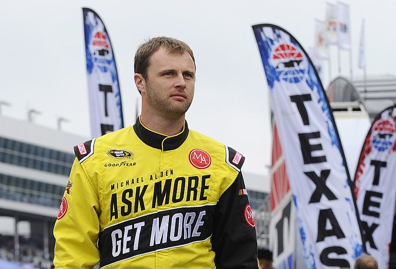 In this April 6, 2014, file photo, Travis Kvapil walks the track before a rain delayed start for the NASCAR Sprint Cup Series auto race at Texas Motor Speedway in Fort Worth, Texas.