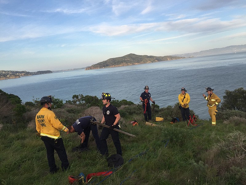 The South Marin County Fire and Rescue suit up to help the National Park rangers pull asuspect to safety Thursday Feb. 26, 2015, in this photo provided by the National Park Service.