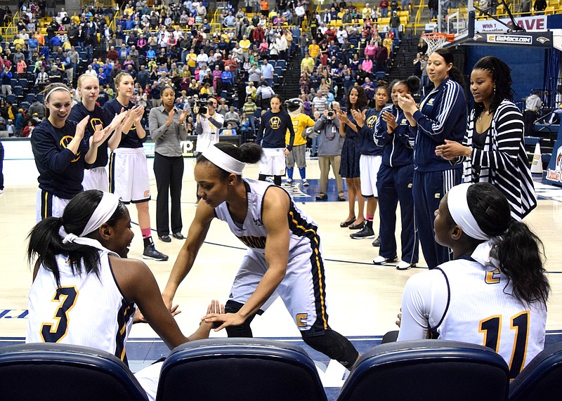 Chelsey Shumpert (25) slaps hands with Jamsmine Joyner (30) as the Mocs are introduced.  The East Tennessee State University Bucs visited the Tennessee Chattanooga Mocs in a Southern Conference Basketball game in McKenzie Arena Saturday.  