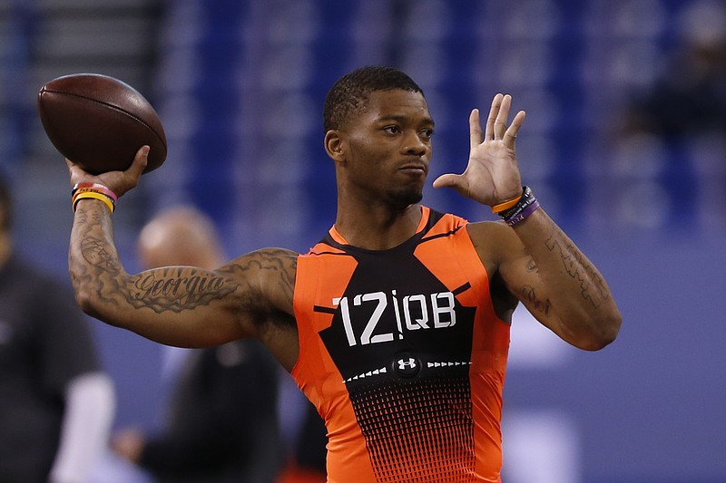 Auburn quarterback Nick Marshall runs a drill at the NFL football scouting combine in Indianapolis on Feb. 21, 2015. 