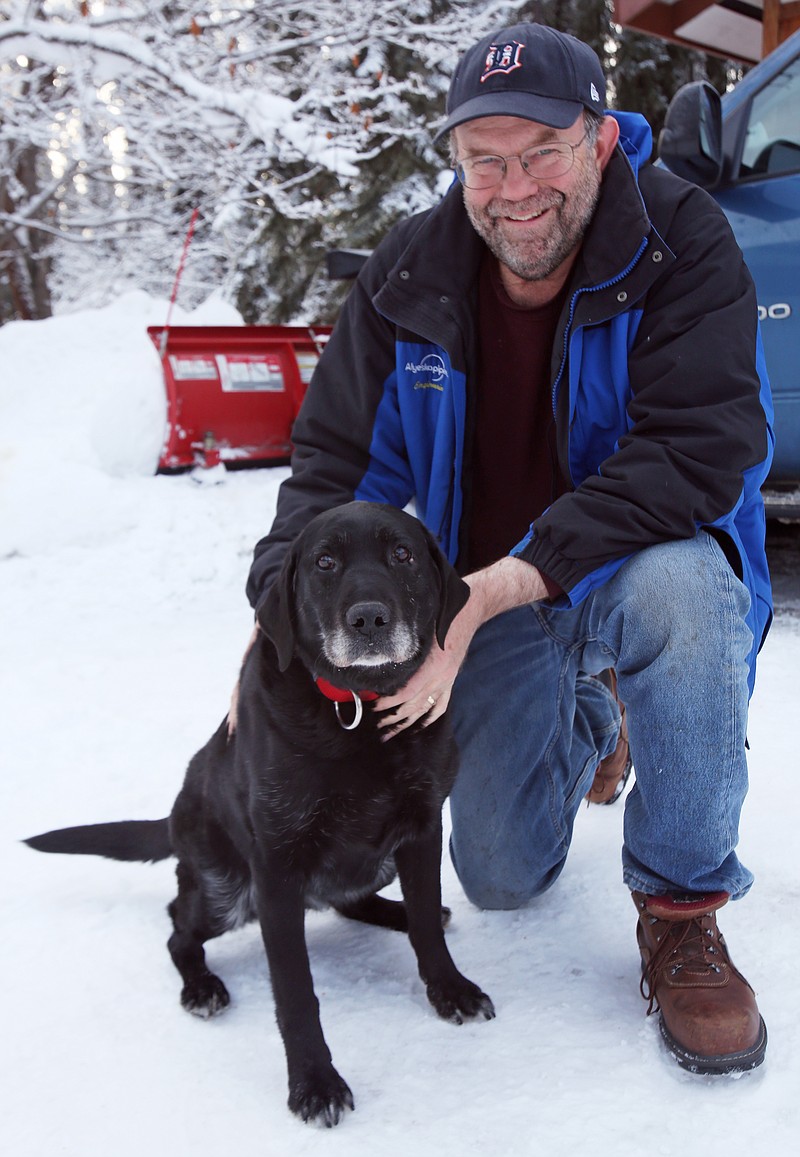 Ed Davis poses with his dog Madera at his home on Feb. 26, 2015, in Ester, Alaska. Madera, who is 11-years old and blind, survived two weeks in sub-zero temperatures after wandering away from home earlier this month. 