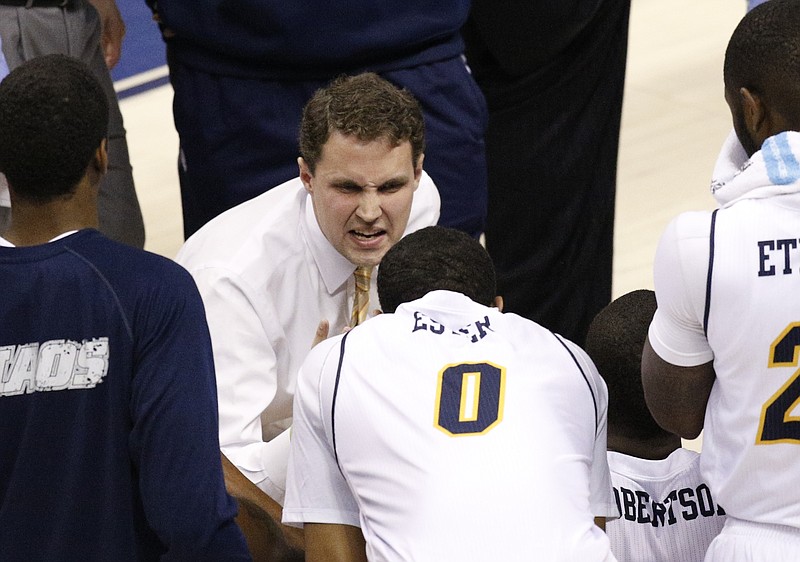 UTC men's basketball coach Will Wade talks to players in a timeout during their game against the Catamounts on Jan. 8, 2015, at McKenzie Arena.