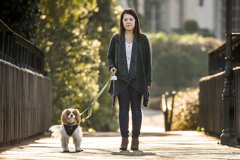
              In this Feb. 25, 2015, photo, Ebola survivor Nina Pham walks in a park with her dog Bentley in Dallas. Pham told The Dallas Morning News in the interview that she is preparing to file a lawsuit Monday, March 2, in Dallas County against Texas Health Resources. She said she continues to suffer from body aches and insomnia after contracting the disease from a patient she cared for last fall at Texas Health Presbyterian Hospital Dallas. (AP Photo/The Dallas Morning News, Smiley N. Pool)  MANDATORY CREDIT; MAGS OUT; TV OUT; INTERNET USE BY AP MEMBERS ONLY; NO SALES
            