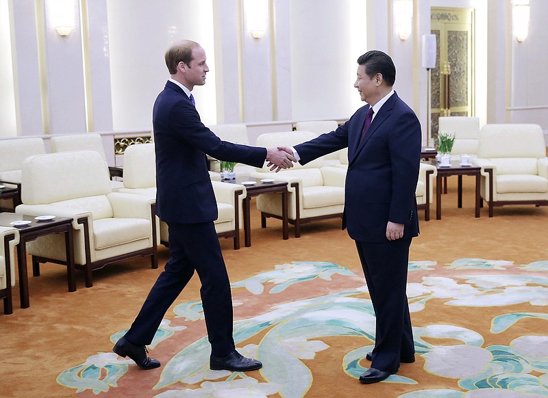 Britain's Prince William, left, meets Chinese President Xi Jinping at the Great Hall of the People in Beijing on Monday, March 2, 2015.  line to the throne.