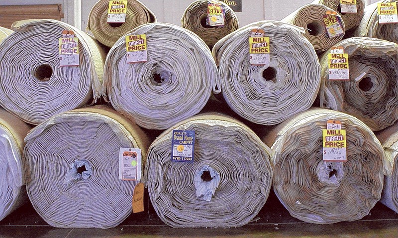 Rolls of carpet made by Shaw Industries line the warehouse of Carpets of Dalton.