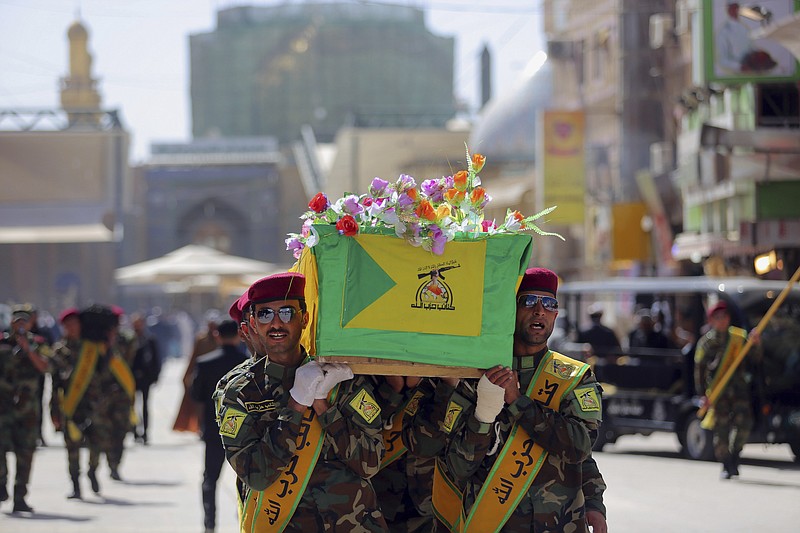 Iraqi Hezbollah fighters carry the coffin of their comrade, Ali Mansour, who his family says was killed in Tikrit fighting Islamic militants, during his funeral procession, in the Shiite holy city of Najaf, 100 miles south of Baghdad, Iraq, on Monday, March 2, 2015.