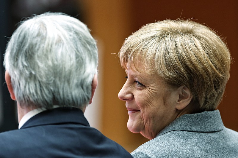 
              German Chancellor Angela Merkel, right, and President of the European Commission Jean-Claude Juncker attend a conference on innovation and competitiveness hosted by the European Investment Bank in Berlin, Germany, Monday, March 2, 2015. (AP Photo/Markus Schreiber)
            